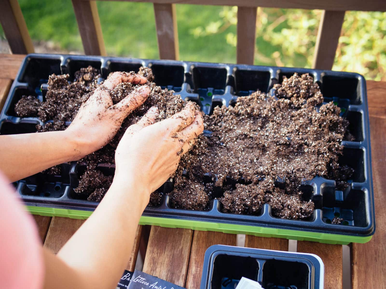 Fill the seed starting tray with pre-moistened seed starting mix