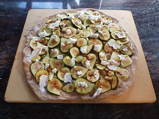 Smear creamy goat cheese over pizza