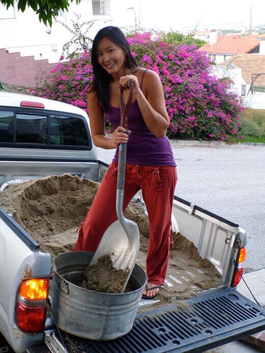 Shoveling sand for the chicken coop