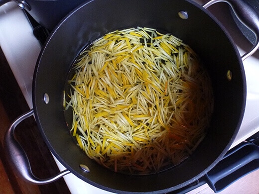 Simmer sliced peels in water until softened