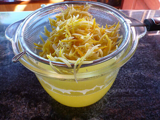 Strain sliced peels and return citrus-infused water to pot
