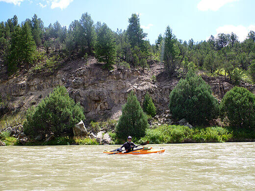 Paddling past desert brush and rocky slopes on the Rio Chama