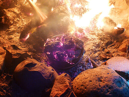Dutch oven cobbler cooking in the fire