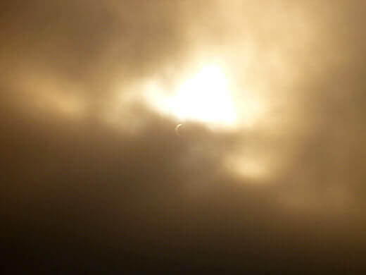 The sun peeking out from behind the clouds