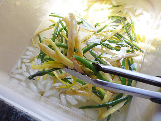 Plunge the blanched beans into a bath of ice water