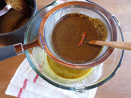 Strain cream mixture into egg yolks