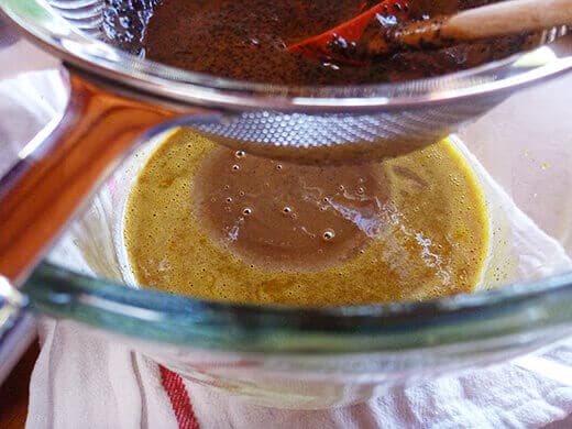 Strain a little bit of the cream mixture at a time to temper the yolks