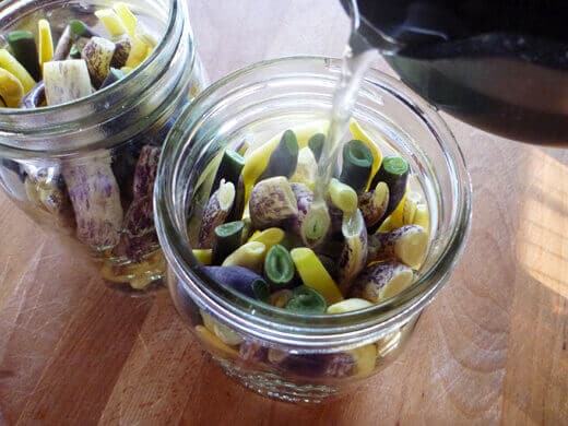 Pour hot brine over the beans