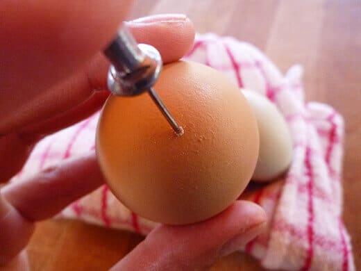 Prick a small hole in the large end of the egg