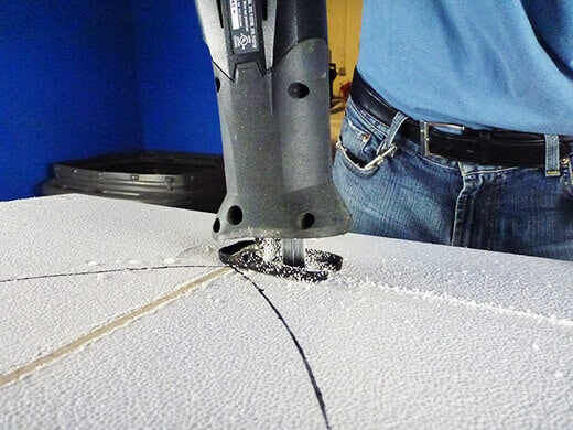 Sawing off the excess foam
