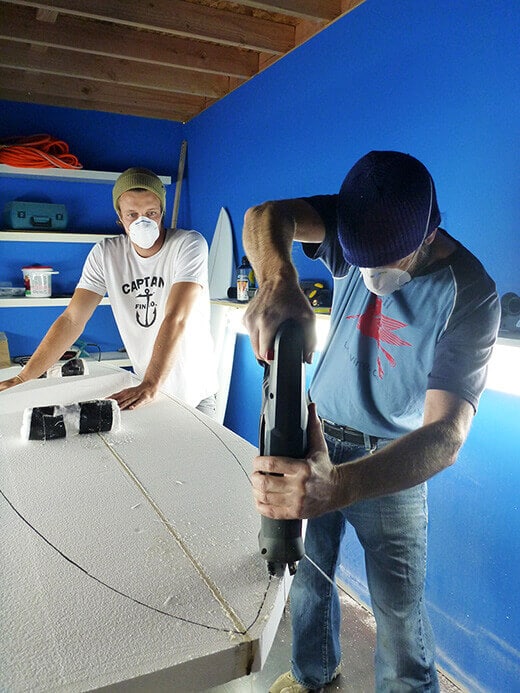 Sawing off the excess foam