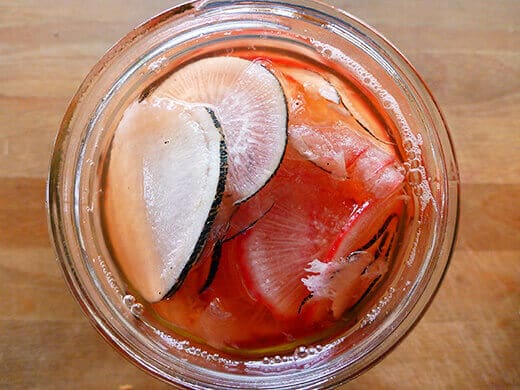 Pour vinegar mixture over radishes