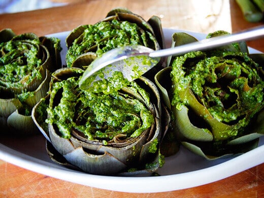 Pour pesto over the artichokes and into the crevices