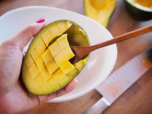 Scoop the avocado flesh into a bowl