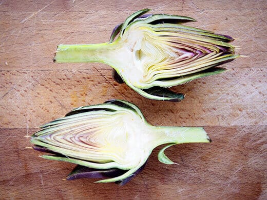 Slice artichoke in half
