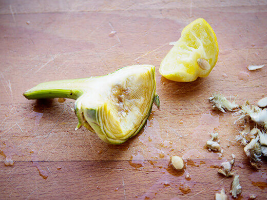 Slice out the choke and rub lemon juice on the flesh