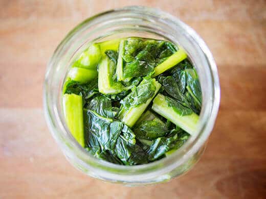 Fill jar with komatsuna, green onions, and Thai bird's eye chili