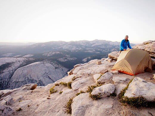 Pitching a tent near the edge of the ridge
