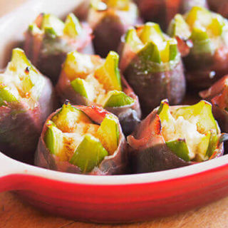 Prosciutto-wrapped and roasted fig stuffed with goat cheese