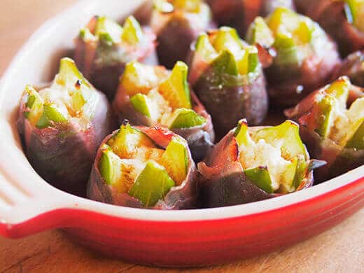 Prosciutto-wrapped and roasted fig stuffed with goat cheese