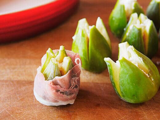 Wrap a strip of prosciutto around each fig