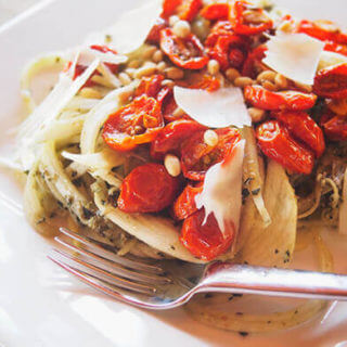 Zucchini noodles with roasted tomatoes, pesto, and pine nuts