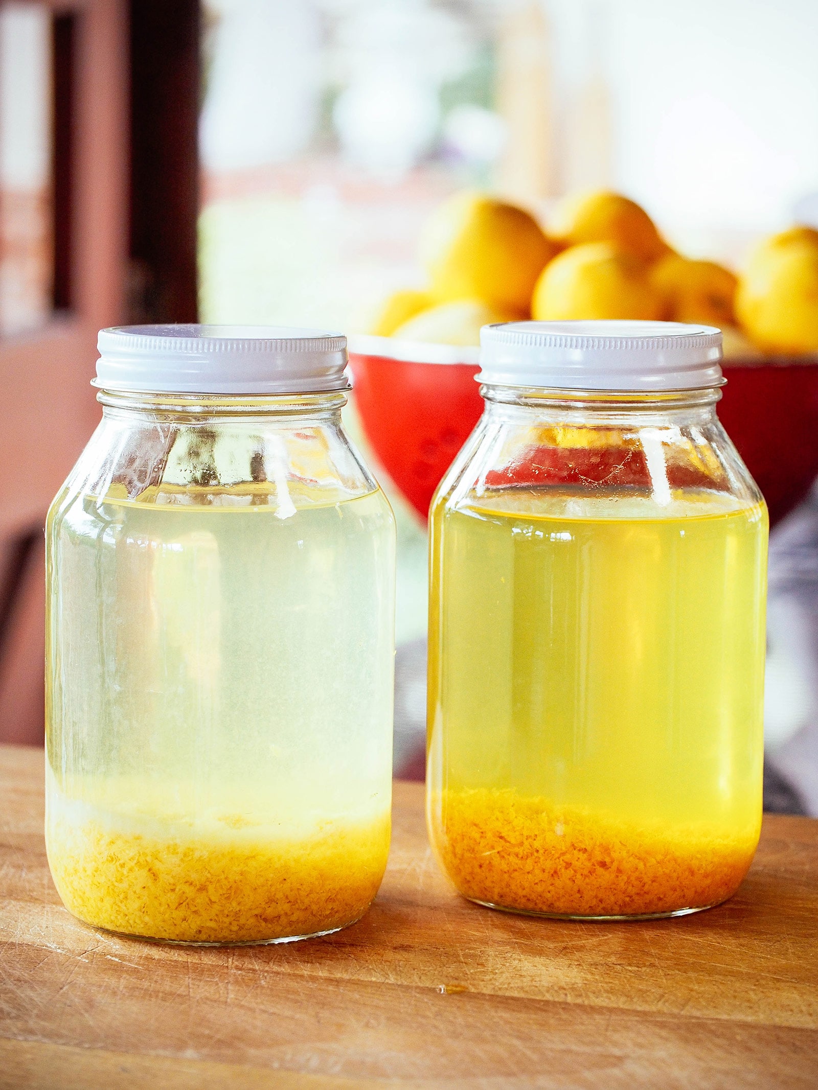 Grapefruit zest and orange zest steeping in high-proof grain alcohol
