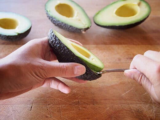 Pry the avocado from its shell in one piece