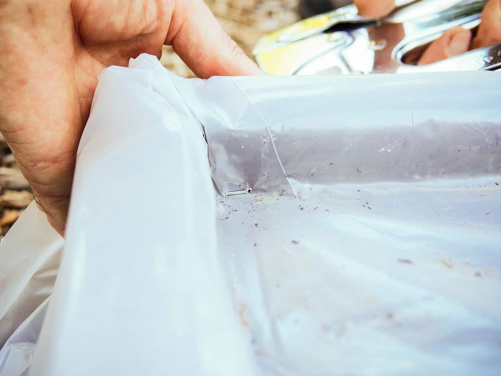 Lay the plastic flat against the soil