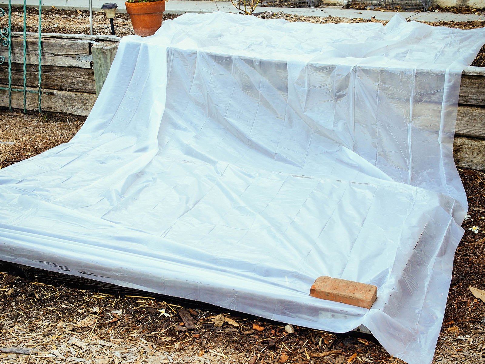Lay the plastic over the bed