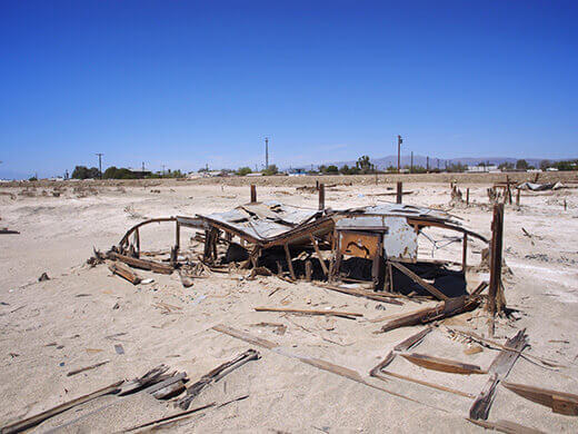 Structure half buried in salty mud