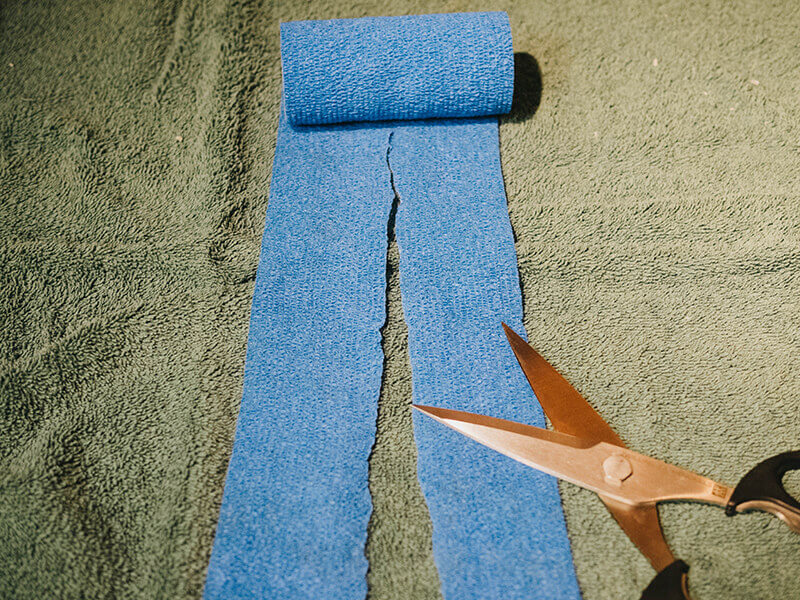 Cutting the Vetwrap bandaging tape to size