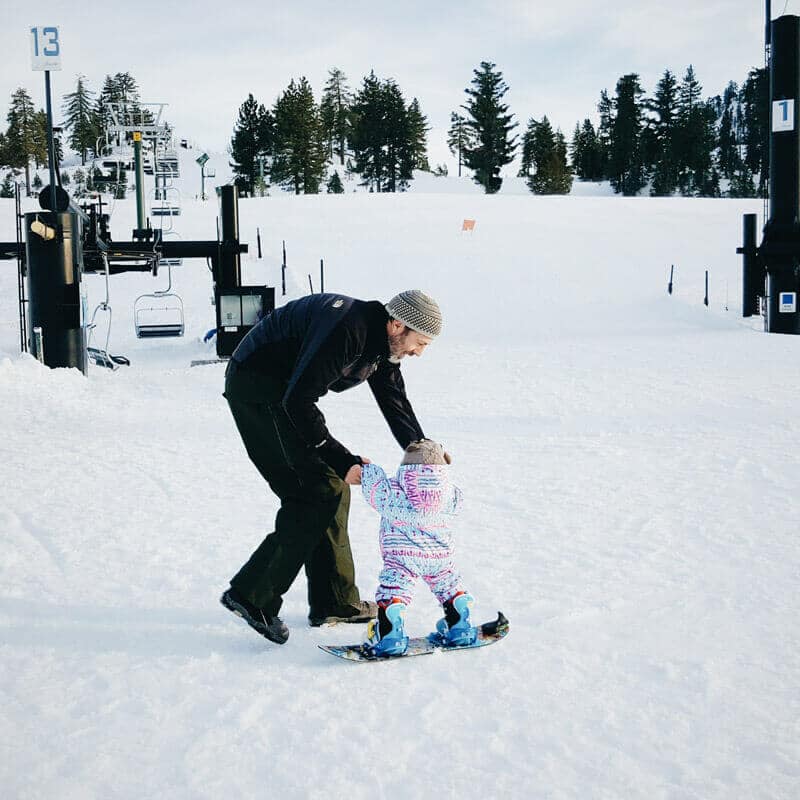 Gliding across the snow with her dad