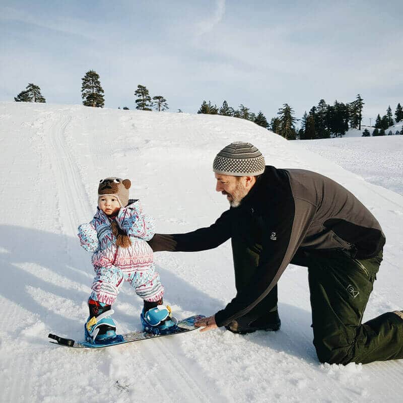 Toddler on a snowboard