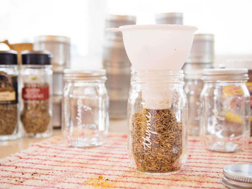 Filling spice bottles with a perfectly sized funnel