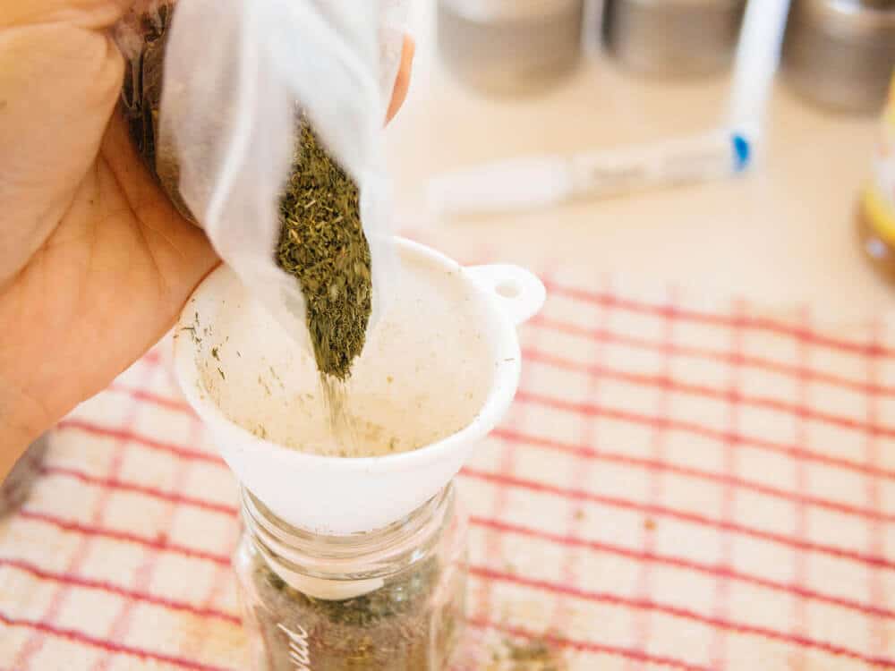 Funneling bulk spices into miniature mason jars