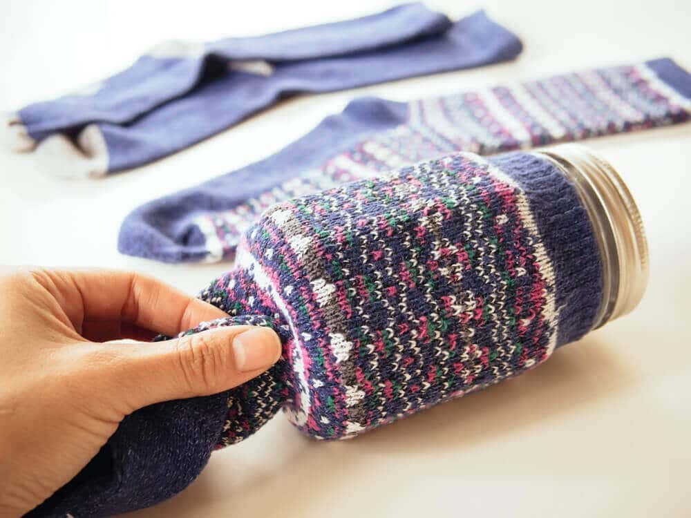 Slide the sock over the jar and cut to length