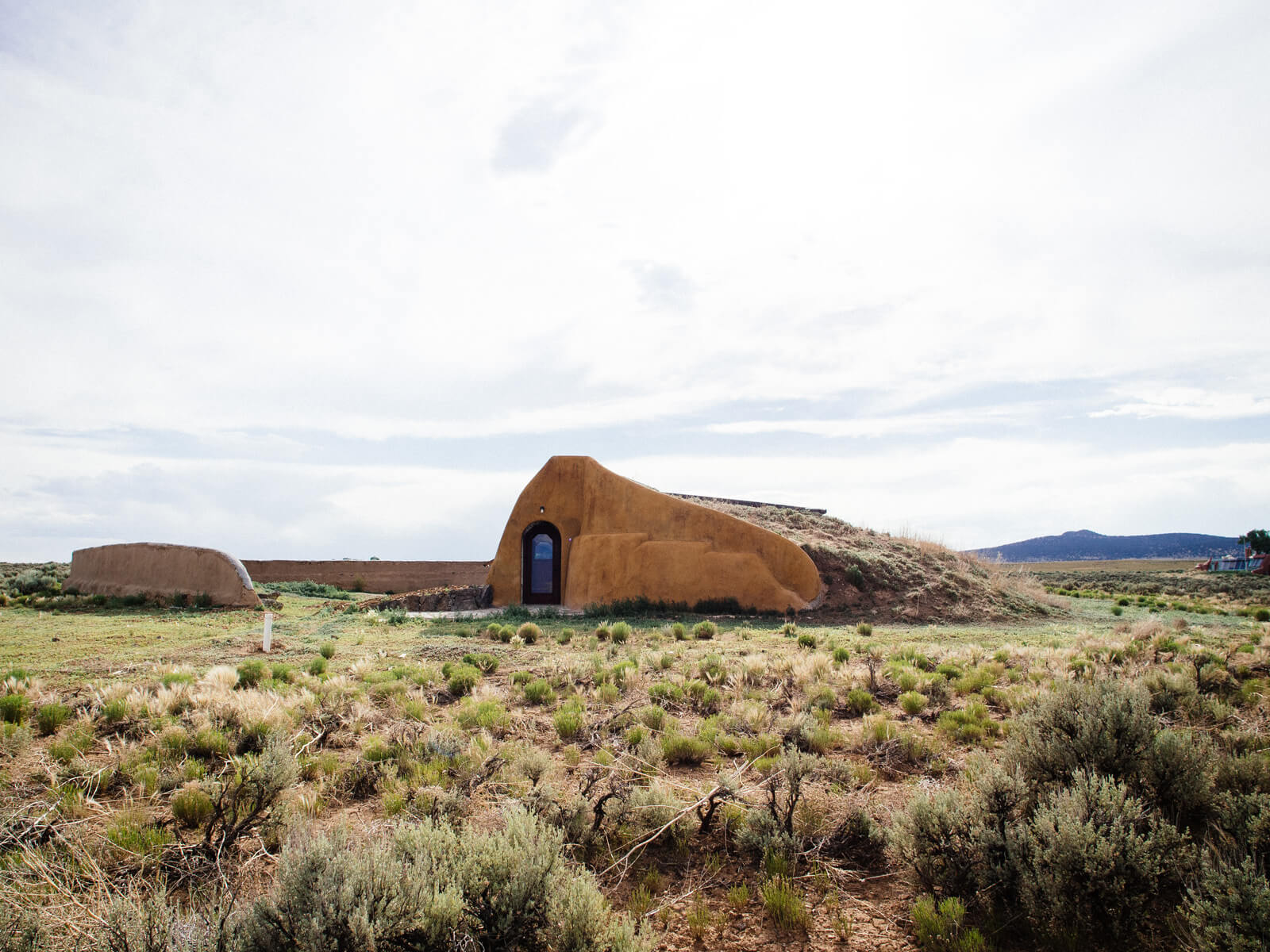 A Global Model Earthship built against a hill