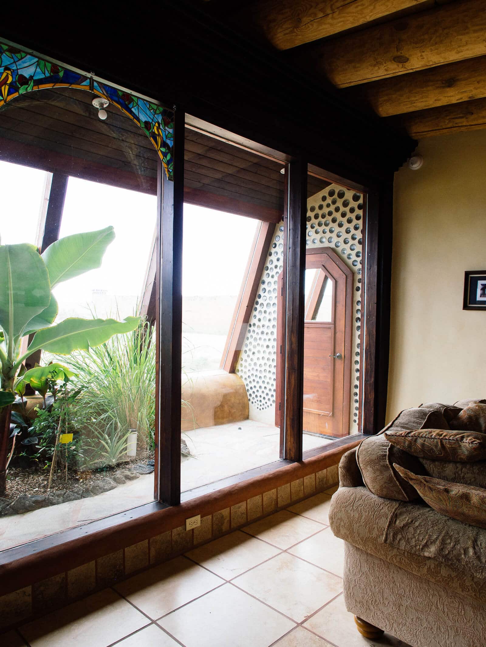 Looking out from the great room to the greenhouse in an Earthship