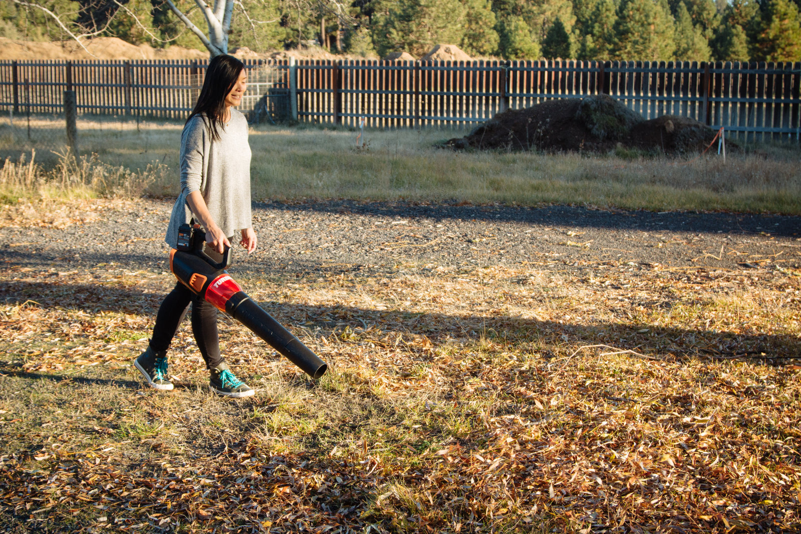 Cleaning up the yard with a cordless blower