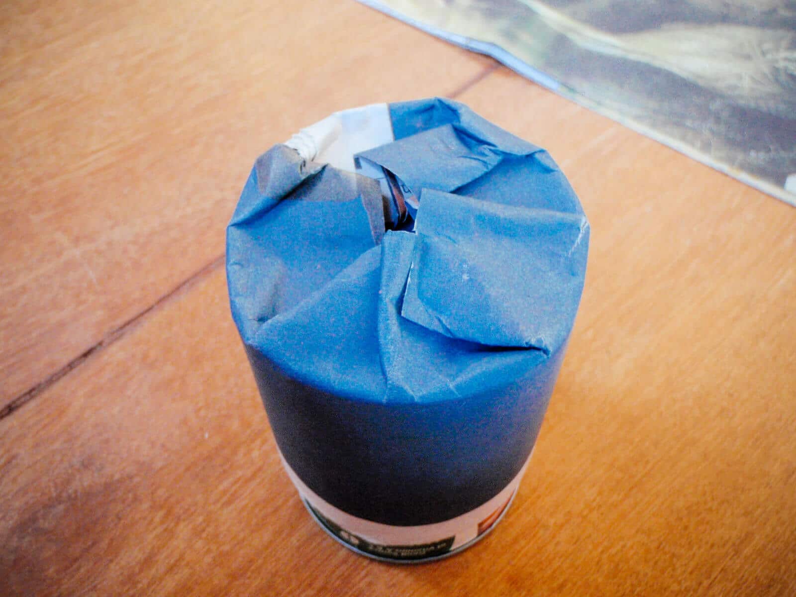 Fold the edges of the newspaper down