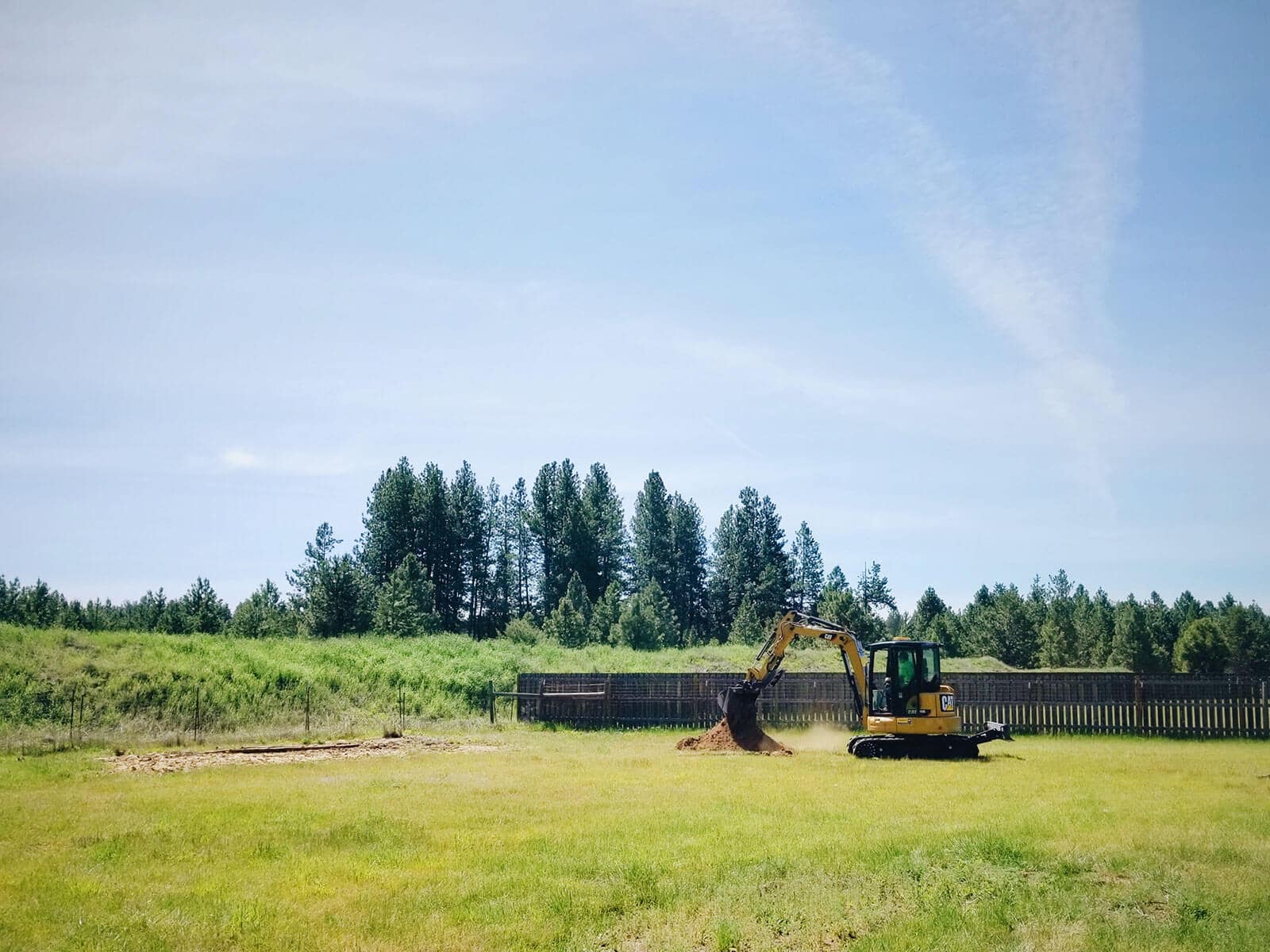 Excavator digging a hole in the backyard