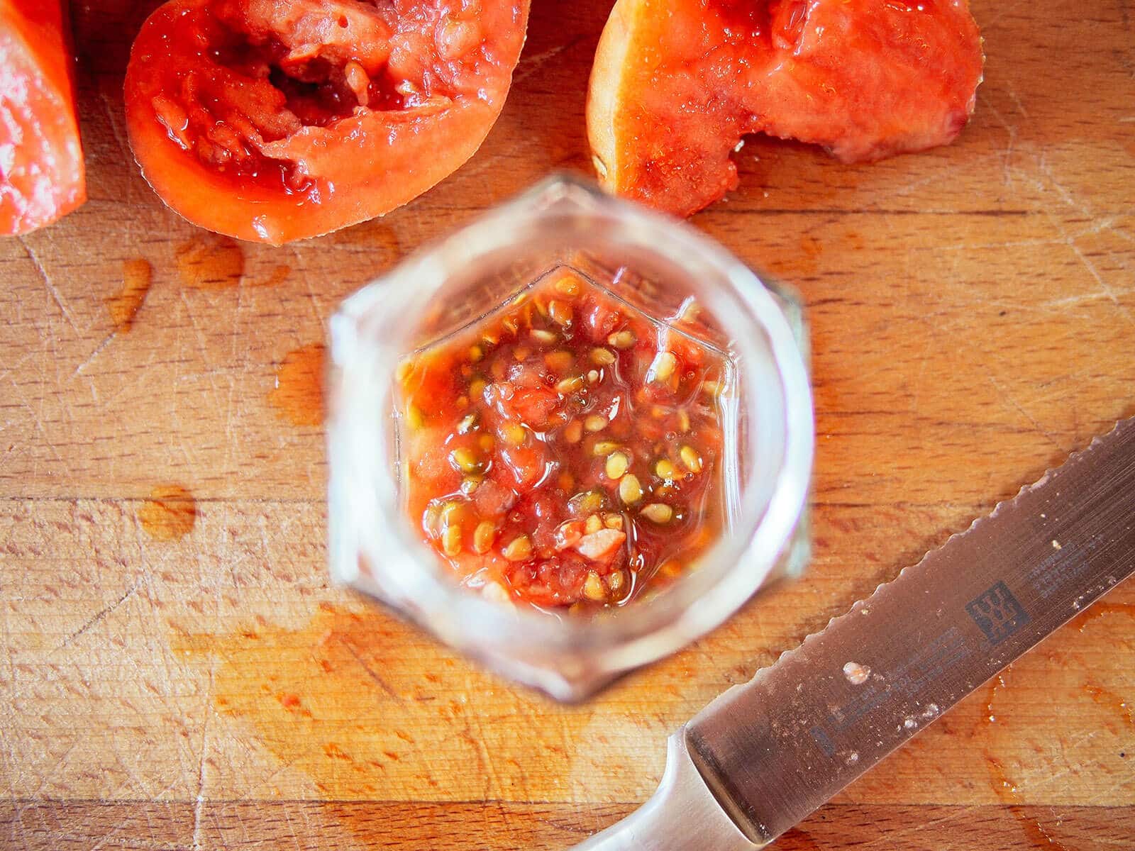 Tomato seeds fermenting in a jar