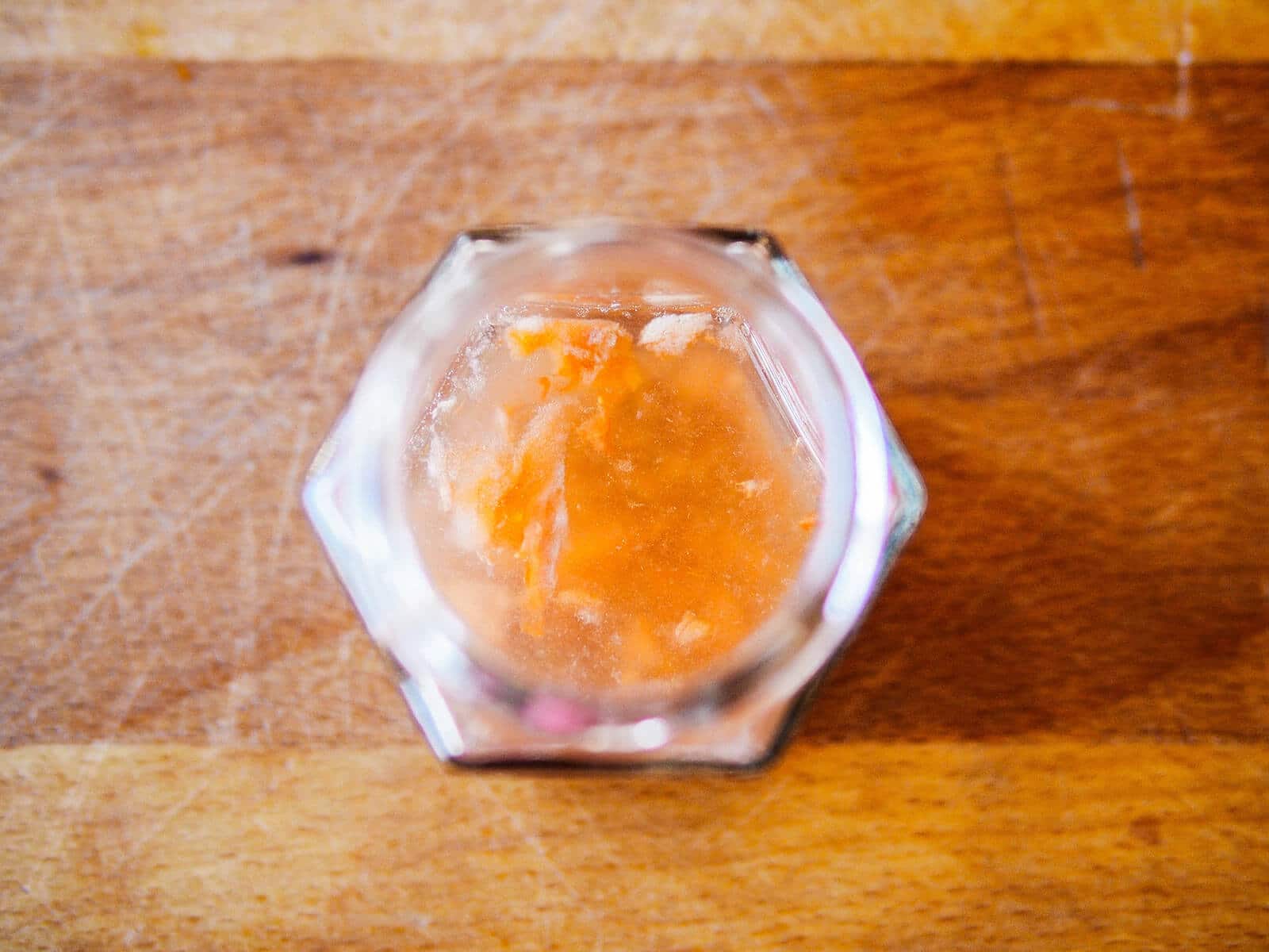 Tomato seeds covered with water to begin the process of fermentation