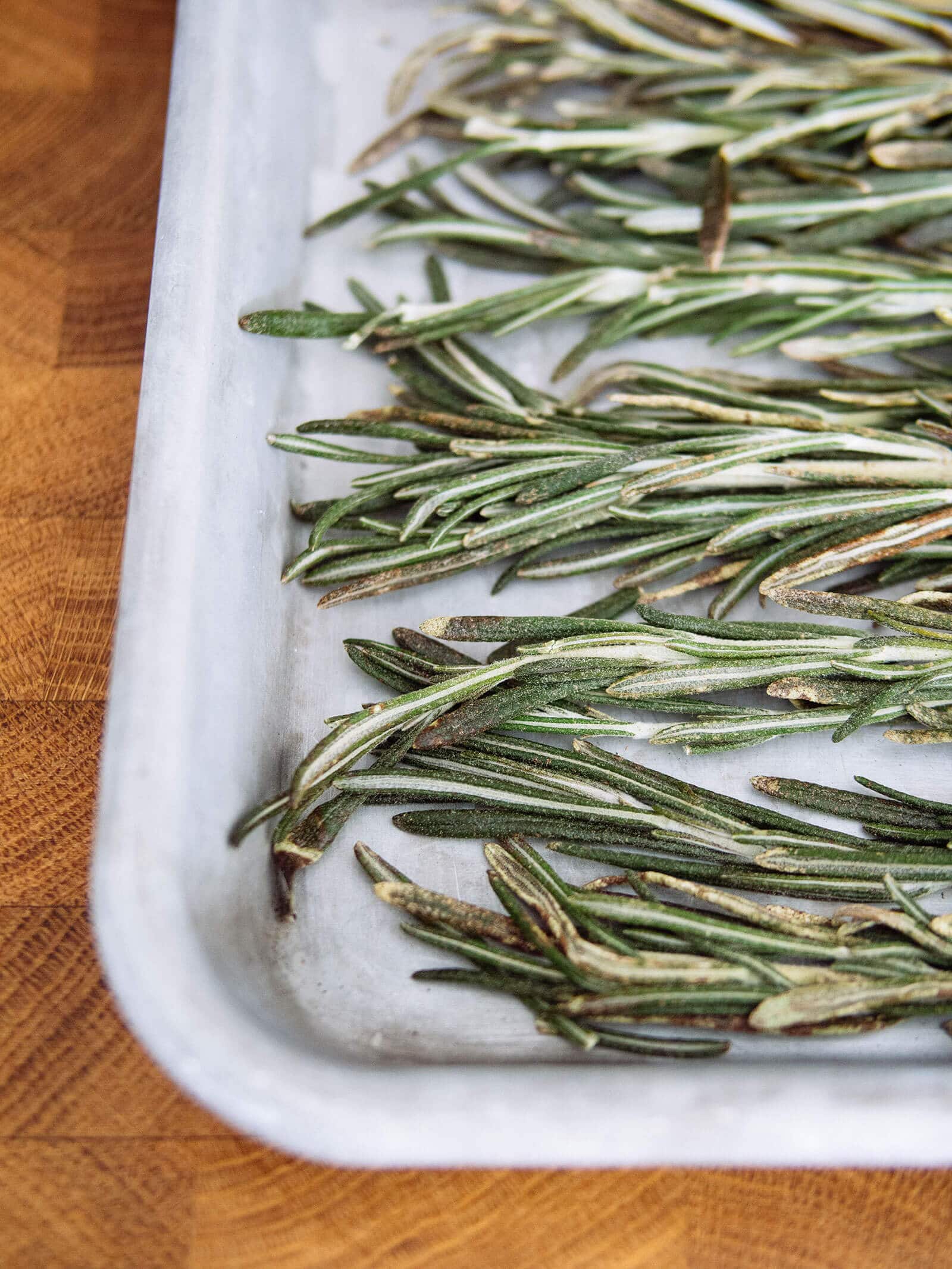 Frozen rosemary sprigs in a sheet pan