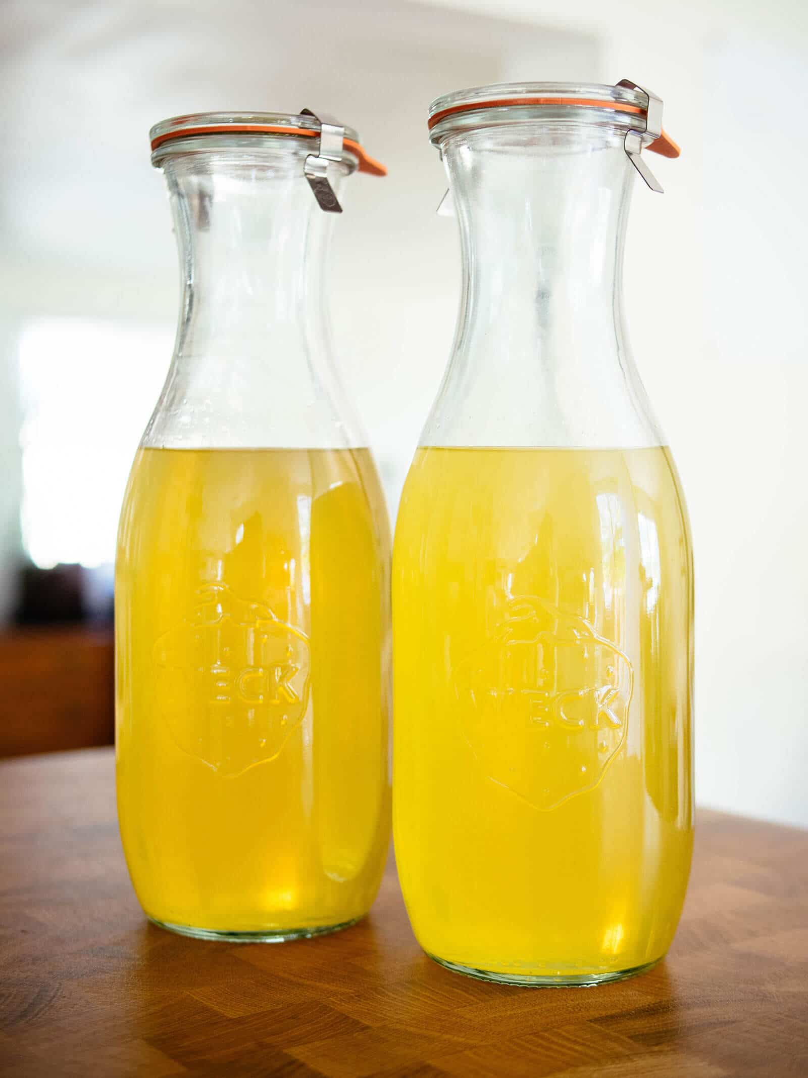 Two Weck juice jars filled with young homemade limoncello