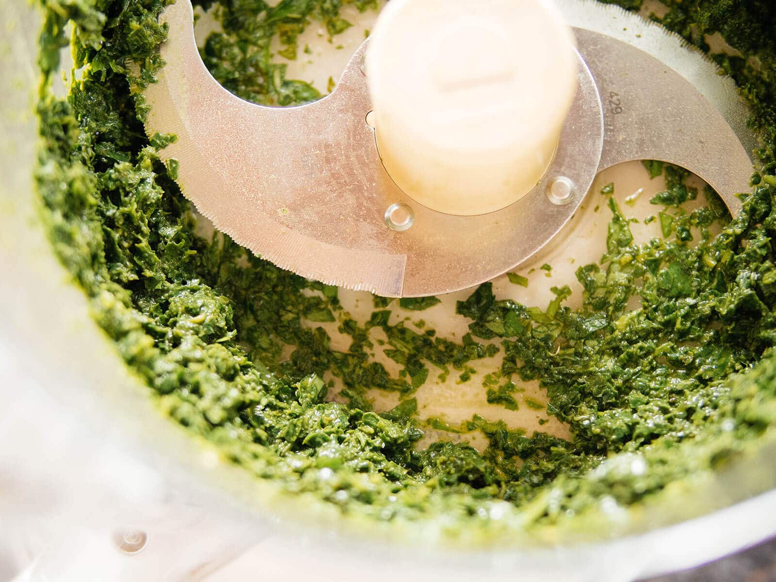 Basil leaves pureed in a food processor and ready to freeze into basil cubes