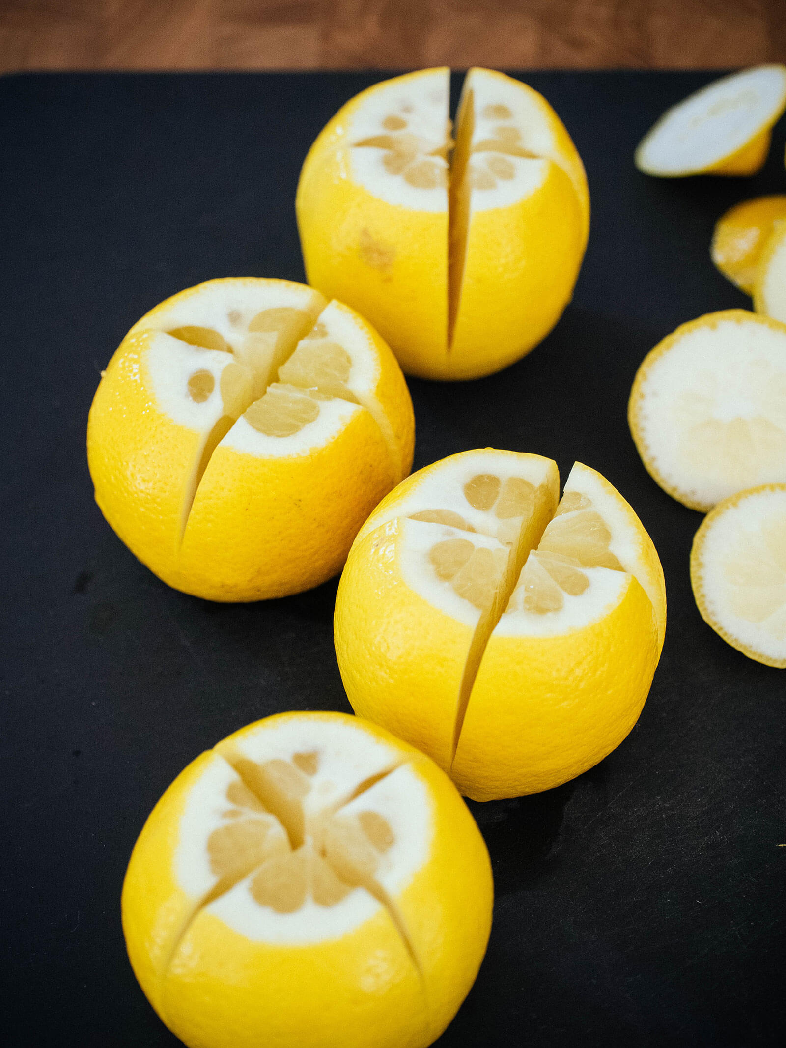 Whole lemons quartered three-fourths of the way through