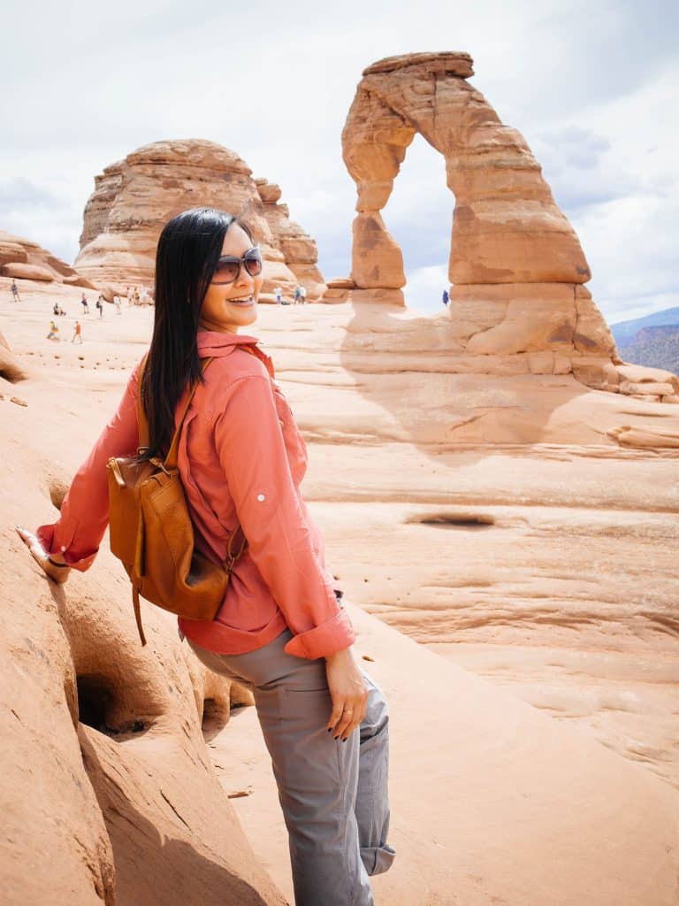 Linda Ly standing in front of the famous arch at Arches National Park
