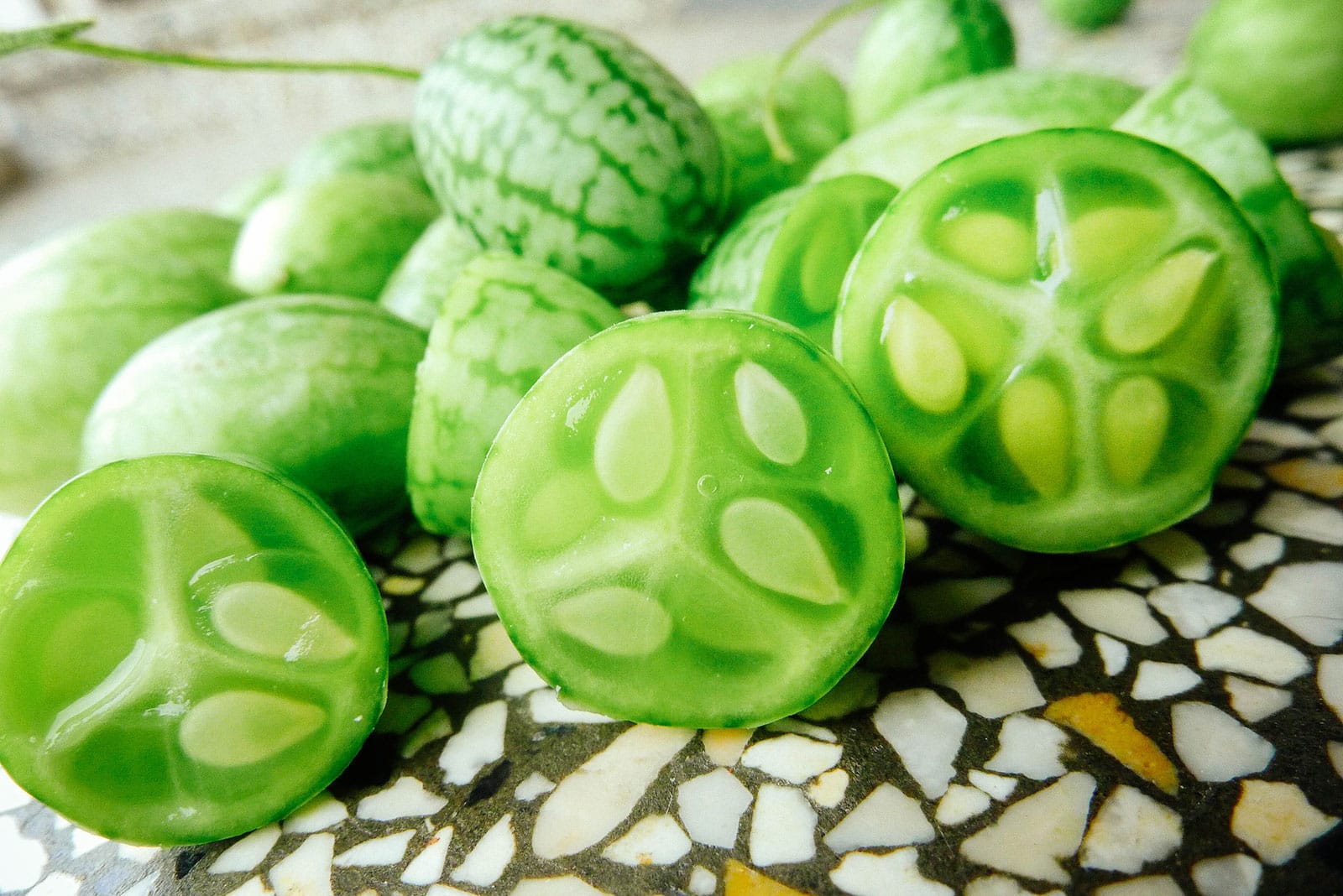 Cucamelons cut open to reveal tiny white seeds inside